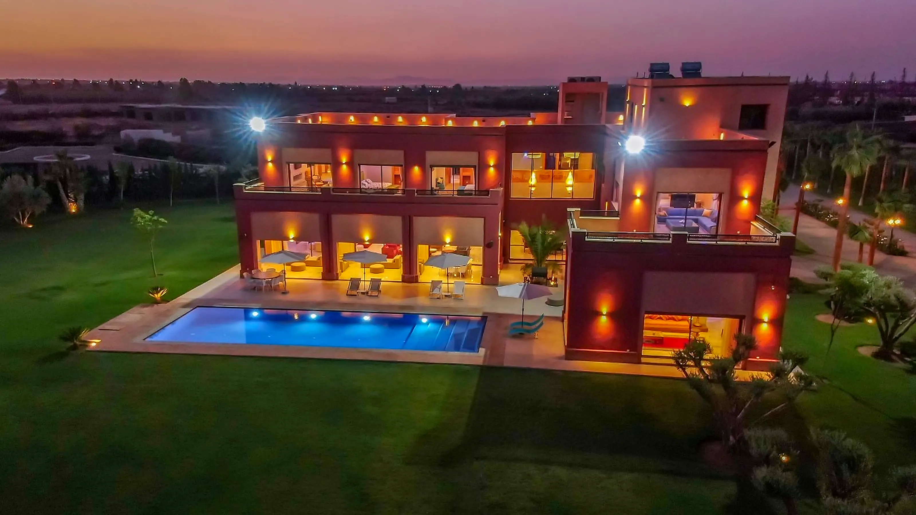 Luxurious midnight blue lounge - Royal blue velvet sofas, Persian rug, marble coffee table and garden terrace view